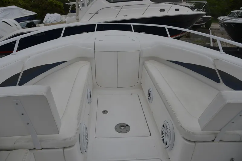 Slide: The Image of 2010 Deep Impact 36 TE boat interior with white seating and speakers. - 14
