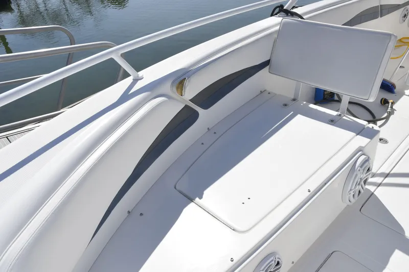 Slide: The Image of 2010 Deep Impact 36 TE boat interior with seating and storage, featuring sleek white design. - 16