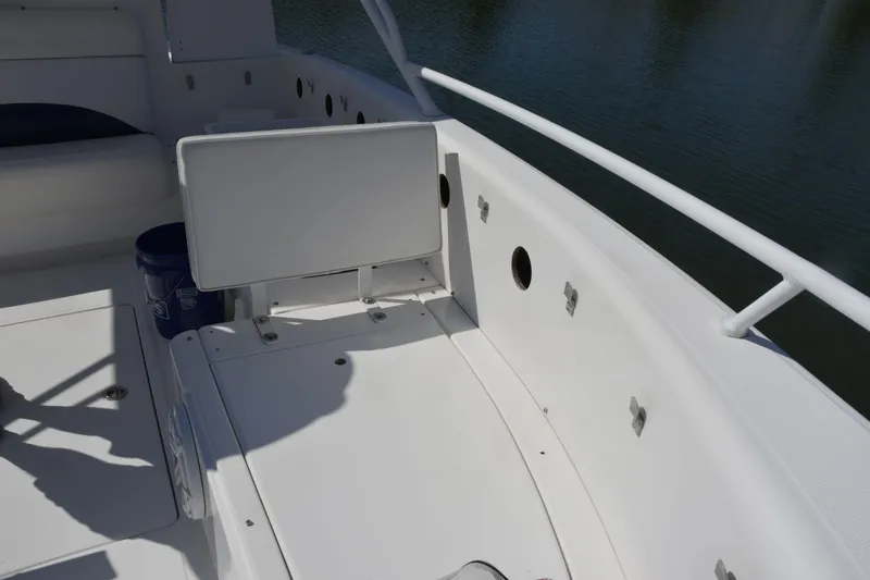 Slide: The Image of 2010 Deep Impact 36 TE boat interior with white seating and storage compartments. - 18