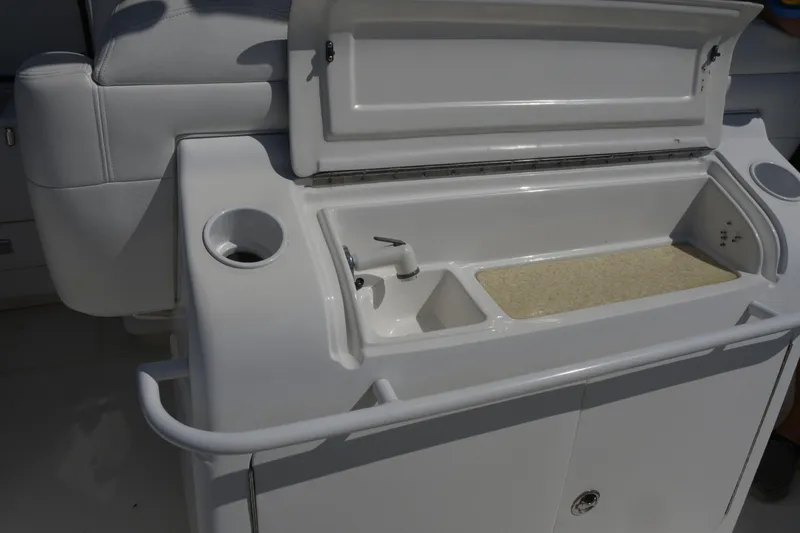 Slide: The Image of 2010 Deep Impact 36 TE boat sink and storage area with open lid. - 2