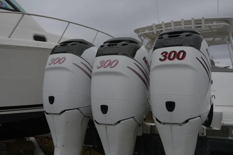 Slide: The Image of Three powerful outboard motors on a 2010 Deep Impact 36 TE boat. - 22