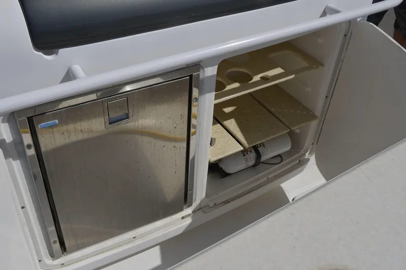 Slide: The Image of Storage compartment on a 2010 Deep Impact 36 TE boat with stainless steel door and shelves. - 3