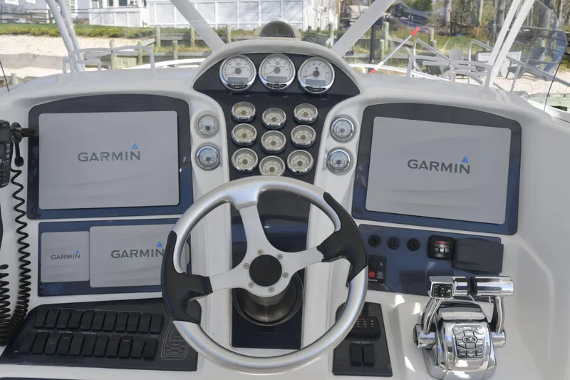 Slide: The Image of Helm of 2010 Deep Impact 36 TE with Garmin navigation displays and controls. - 5