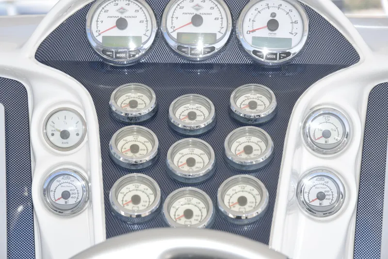 Slide: The Image of Dashboard of a 2010 Deep Impact 36 TE boat with multiple gauges and dials. - 6