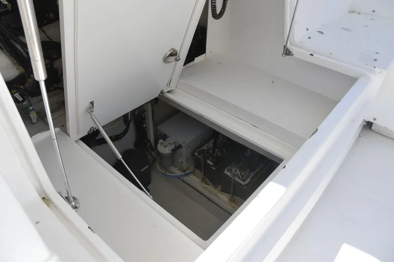 Slide: The Image of Open storage compartment on a 2010 Deep Impact 36 TE boat, showing interior equipment. - 8