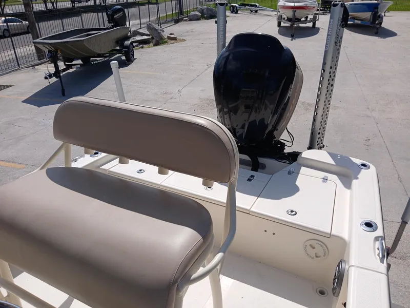 Slide: The Image of 2013 BlackJack 224 boat with seating and outboard motor in a marina setting. - 2