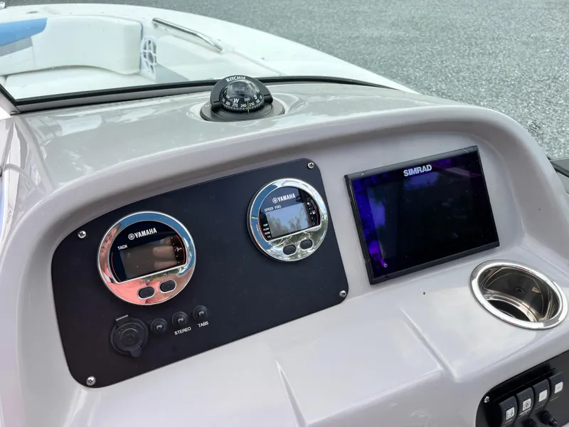 Slide: The Image of 2024 Robalo R207 Dual Console dashboard with Simrad displays and controls. - 12