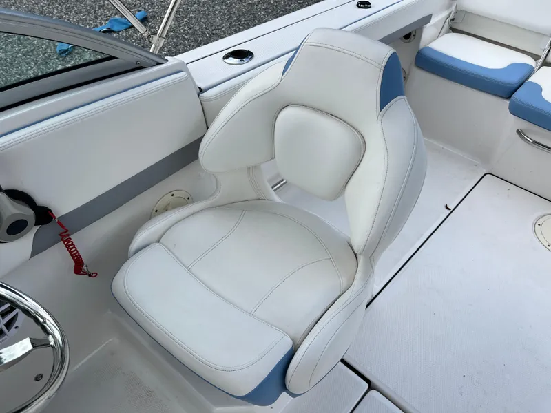 Slide: The Image of 2024 Robalo R207 Dual Console boat seat, white and blue upholstery, modern design. - 16