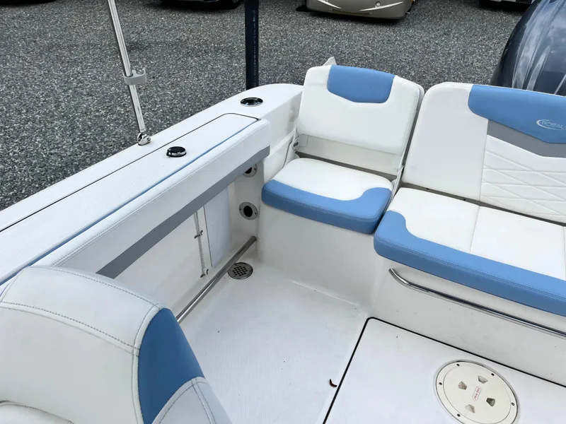 Slide: The Image of 2024 Robalo R207 Dual Console boat interior with white and blue seating. - 17