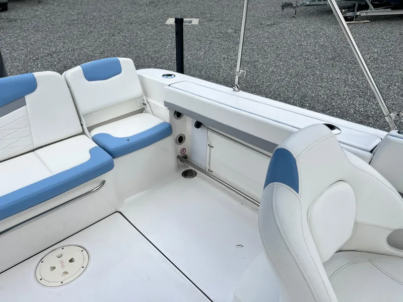 Slide: The Image of 2024 Robalo R207 Dual Console boat interior with white and blue seating. - 19