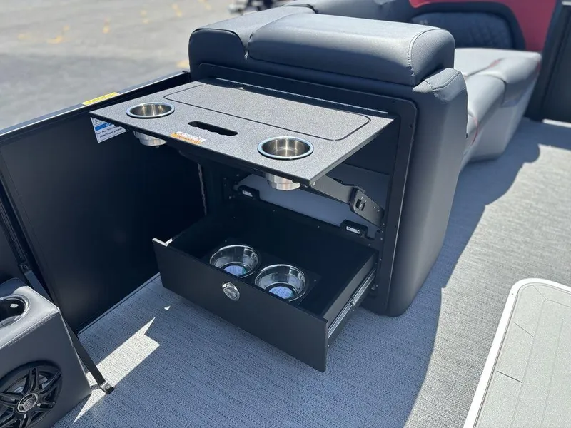 Slide: The Image of 2025 Godfrey SWEETWATER 2286 SFL boat interior with cup holders and storage drawer. - 12