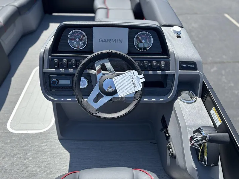 Slide: The Image of Steering console of 2025 Godfrey SWEETWATER 2286 SFL with Garmin display and controls. - 16