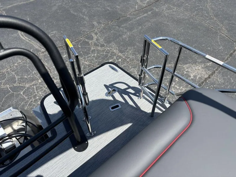 Slide: The Image of 2025 Godfrey SWEETWATER 2286 SFL boat deck with sleek railing and seating. - 23