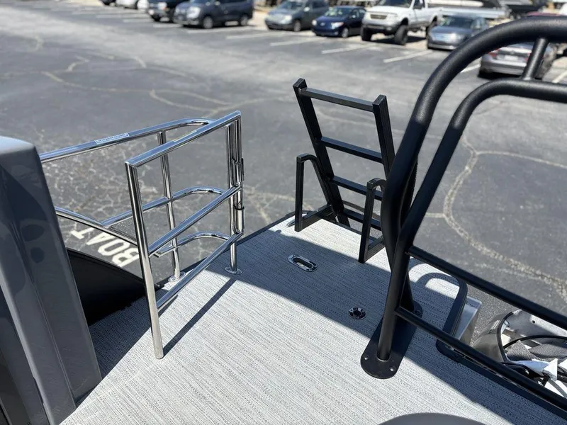 Slide: The Image of 2025 Godfrey SWEETWATER 2286 SFL boat deck with safety railings and ladder. - 25