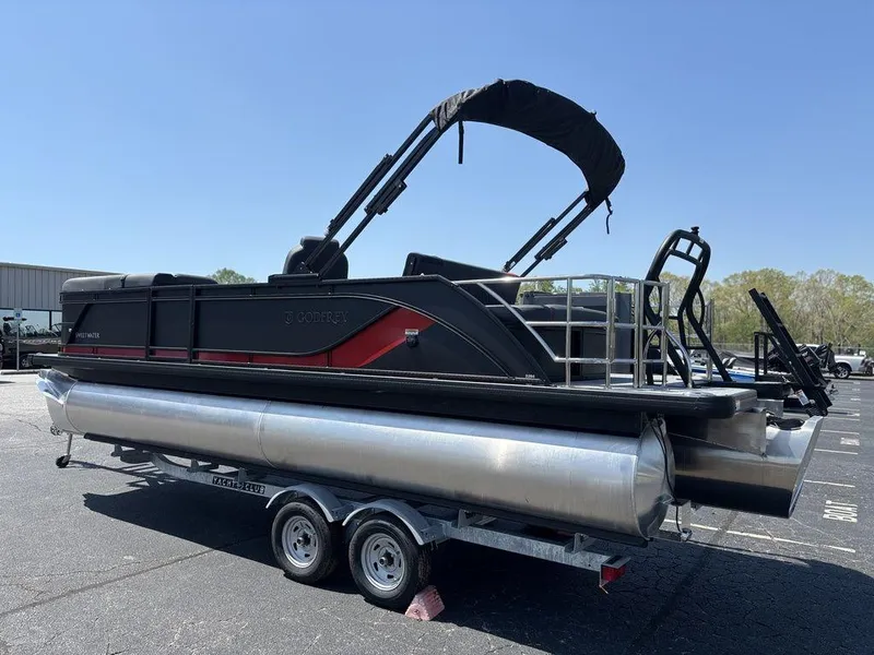 Slide: The Image of 2025 Godfrey SWEETWATER 2286 SFL pontoon boat on trailer, black and red design. - 3