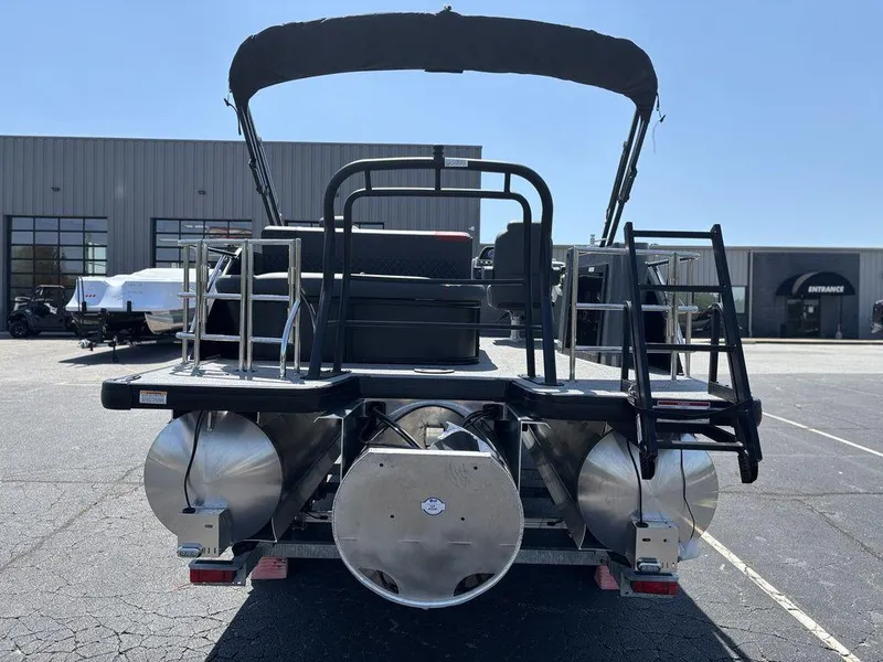 Slide: The Image of 2025 Godfrey SWEETWATER 2286 SFL pontoon boat, rear view, in a parking lot. - 4