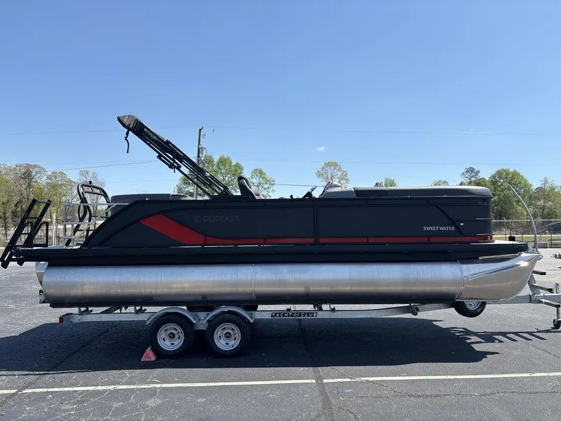 Slide: The Image of 2025 Godfrey SWEETWATER 2286 SFL pontoon boat on trailer, parked outdoors. - 6