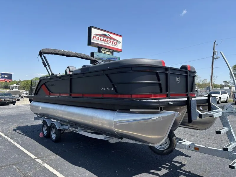 Slide: The Image of 2025 Godfrey SWEETWATER 2286 SFL pontoon boat on trailer, parked outdoors. - 7