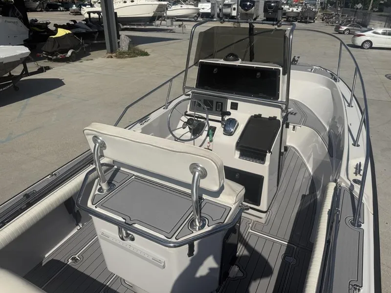 Slide: The Image of 1996 Boston Whaler 21 Outrage boat interior with steering console and seating. - 19