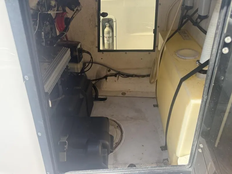 Slide: The Image of Interior view of a 1996 Boston Whaler 21 Outrage boat, showing equipment and storage area. - 26
