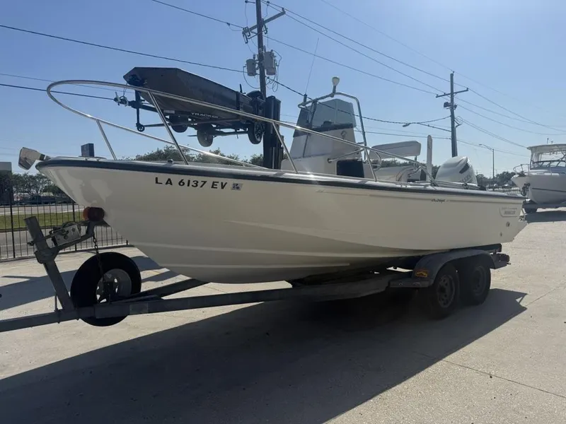 Slide: The Image of 1996 Boston Whaler 21 Outrage boat on trailer, parked outdoors. - 9