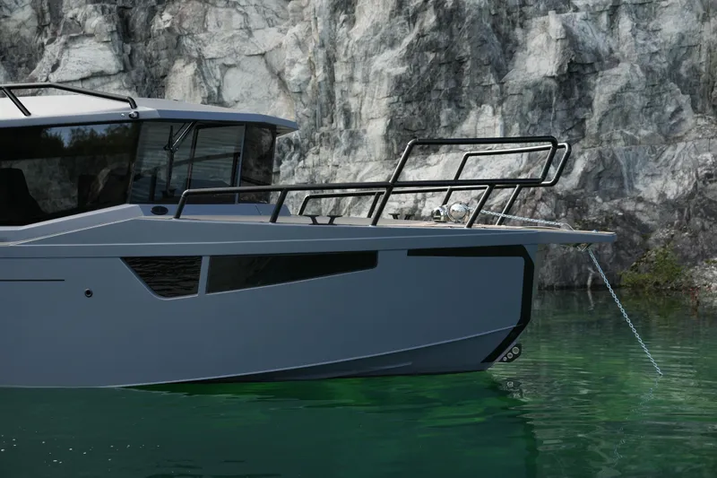 Slide: The Image of Jaktar J30 Black Vision 2026 yacht in serene waters near rocky cliffs. - 14