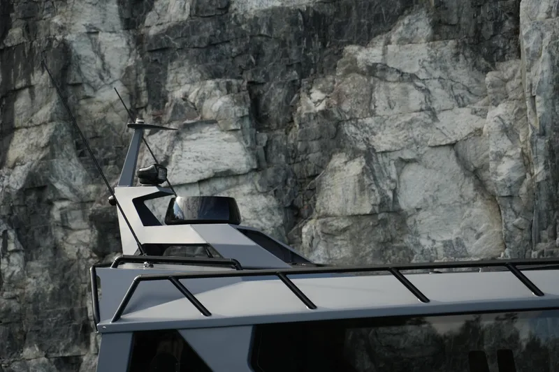 Slide: The Image of Jaktar J30 Black Vision 2026 yacht against rocky cliff background. - 15