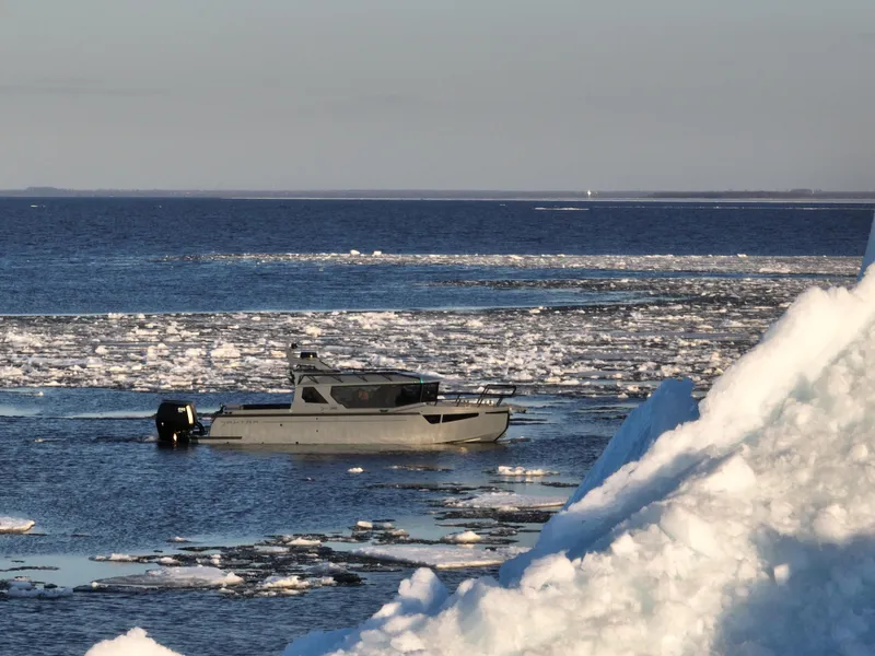 Slide: The Image of Jaktar J30 Black Vision boat navigating icy waters, 2026 model. - 25