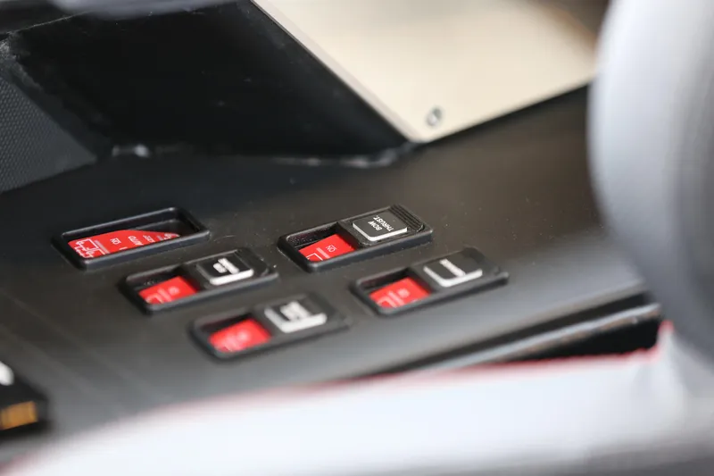 Slide: The Image of Close-up of 2026 Jaktar J30 Black Vision dashboard controls with red and black buttons. - 28