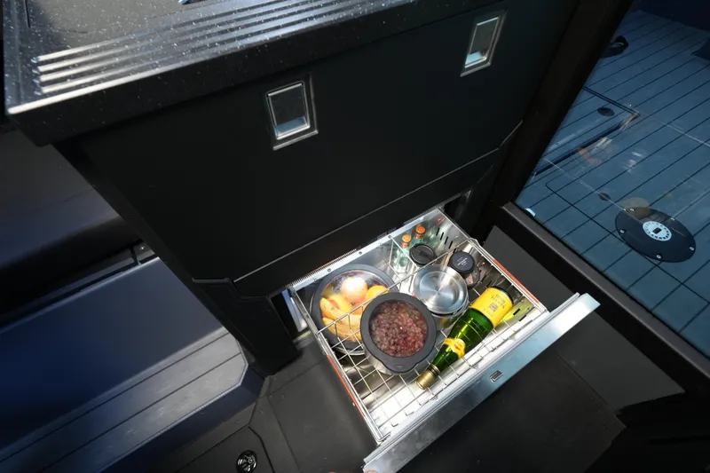 Slide: The Image of Drawer refrigerator in Jaktar J30 Black Vision 2026, stocked with food and drinks. - 4