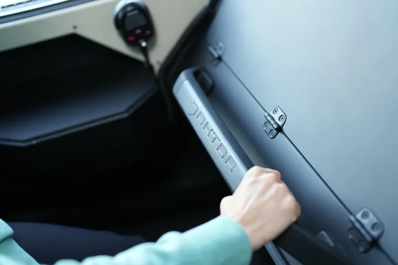 Slide: The Image of Person opening Jaktar J30 Black Vision glove compartment, 2026 model. - 7