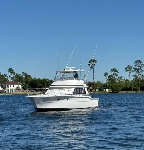 Slide: The Image of 1989 Ricker 48 Convertible yacht cruising on a sunny day. - 24