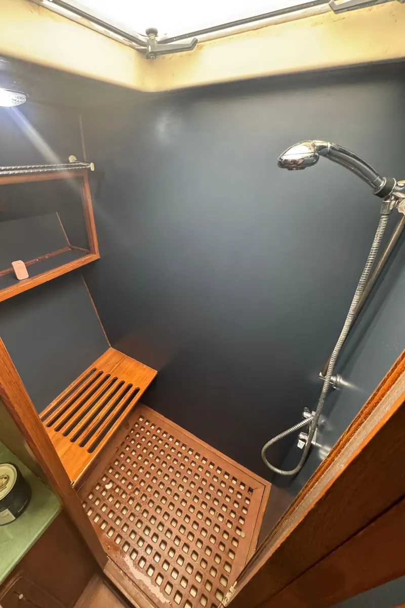 Slide: The Image of 1989 Ricker 48 Convertible yacht shower with wooden bench and modern fixtures. - 34