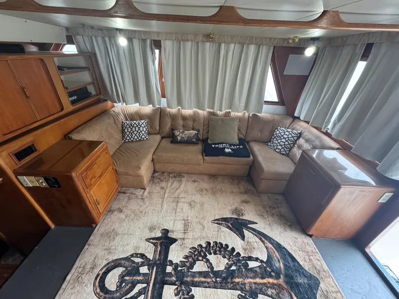 Slide: The Image of Luxurious interior of 1989 Ricker 48 Convertible yacht with plush seating and nautical-themed decor. - 5