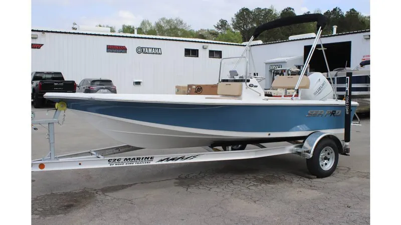 Slide: The Image of 2025 Sea Pro 172 boat on trailer, blue hull, parked outside dealership. - 0