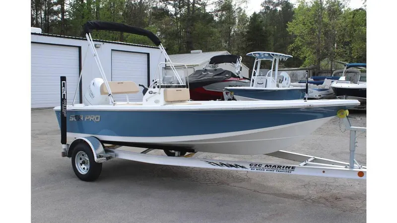 Slide: The Image of 2025 Sea Pro 172 boat on trailer, parked outdoors near storage units. - 1