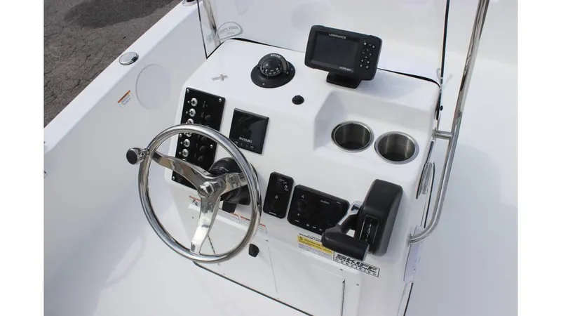Slide: The Image of 2025 Sea Pro 172 boat console with steering wheel, gauges, and cup holders. - 11