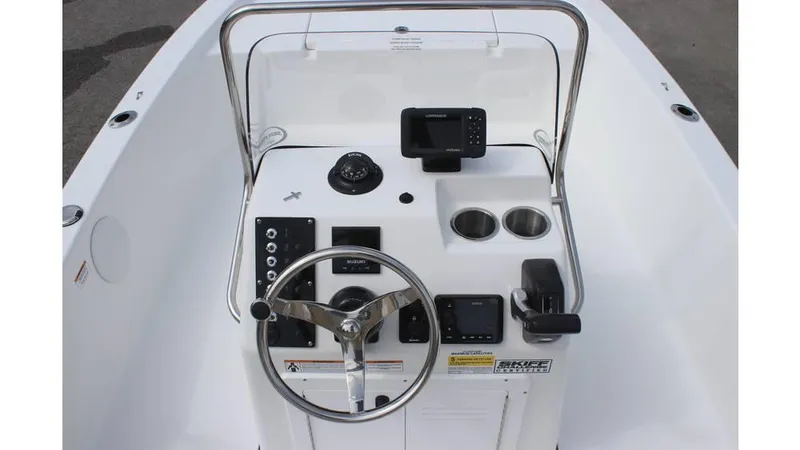 Slide: The Image of 2025 Sea Pro 172 boat console with steering wheel, gauges, and cup holders. - 12