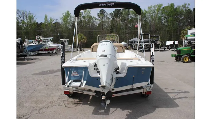 Slide: The Image of 2025 Sea Pro 172 boat with outboard motor, parked in a marina lot. - 3