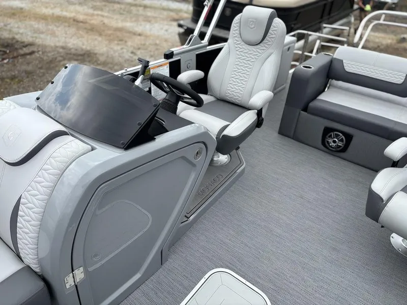 Slide: The Image of 2025 Godfrey Monaco 235 DFL boat interior with modern helm and seating. - 13