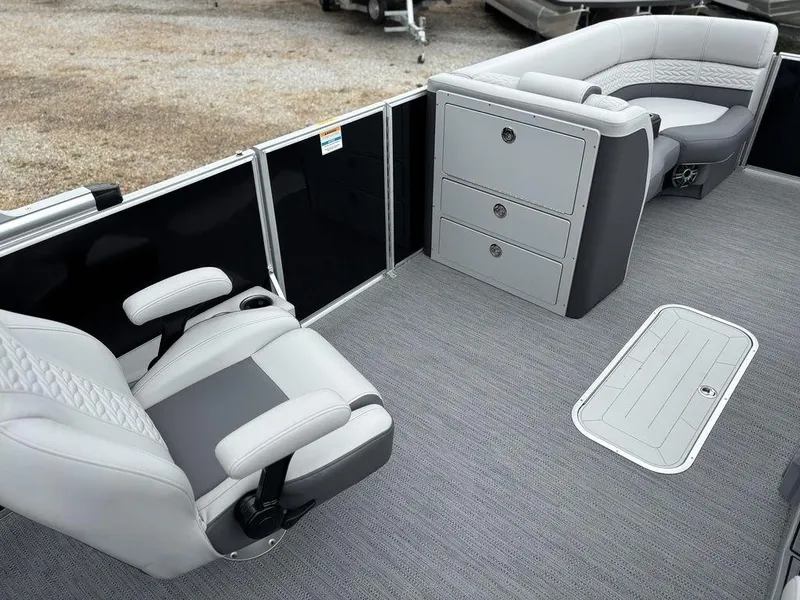 Slide: The Image of 2025 Godfrey Monaco 235 DFL boat interior with gray seating and storage compartments. - 14