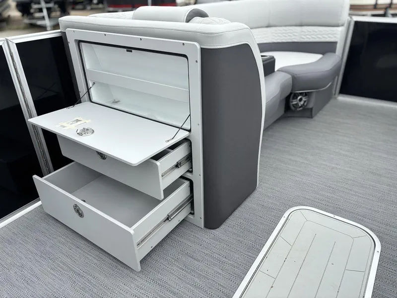 Slide: The Image of 2025 Godfrey Monaco 235 DFL boat interior with open storage compartments and seating. - 15