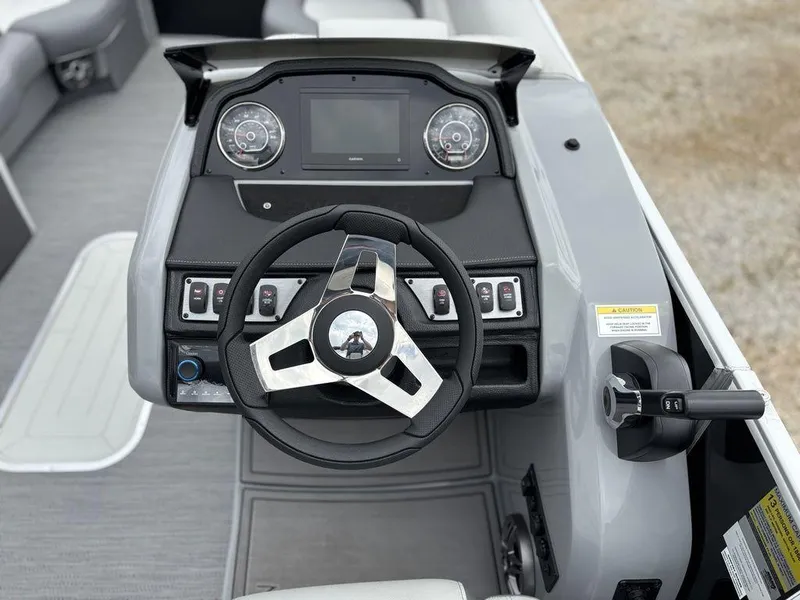 Slide: The Image of 2025 Godfrey Monaco 235 DFL boat dashboard with steering wheel and control panel. - 16
