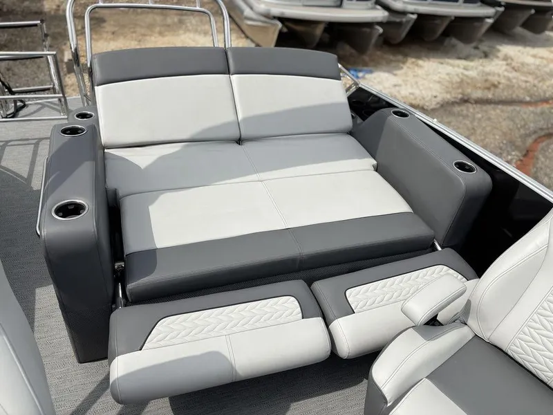 Slide: The Image of 2025 Godfrey Monaco 235 DFL boat interior with luxurious seating and cup holders. - 21