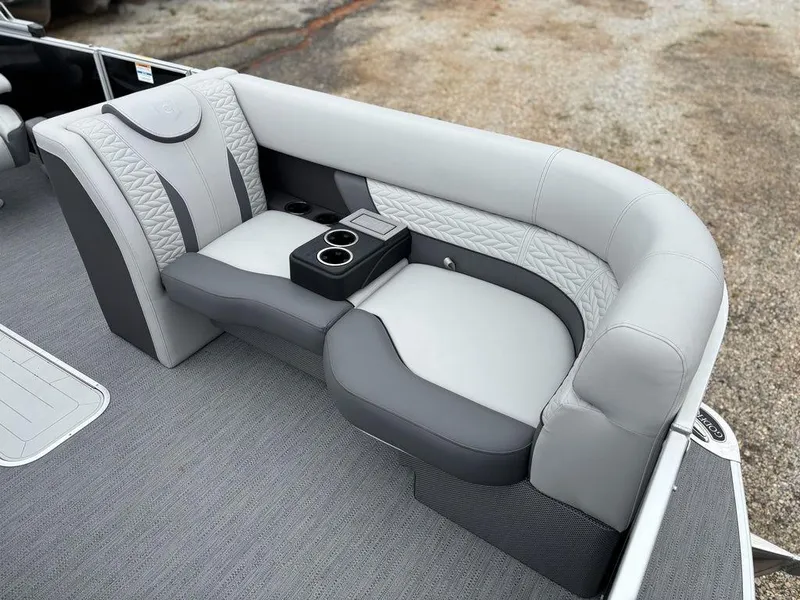 Slide: The Image of 2025 Godfrey Monaco 235 DFL boat seating with gray upholstery and cup holders. - 9