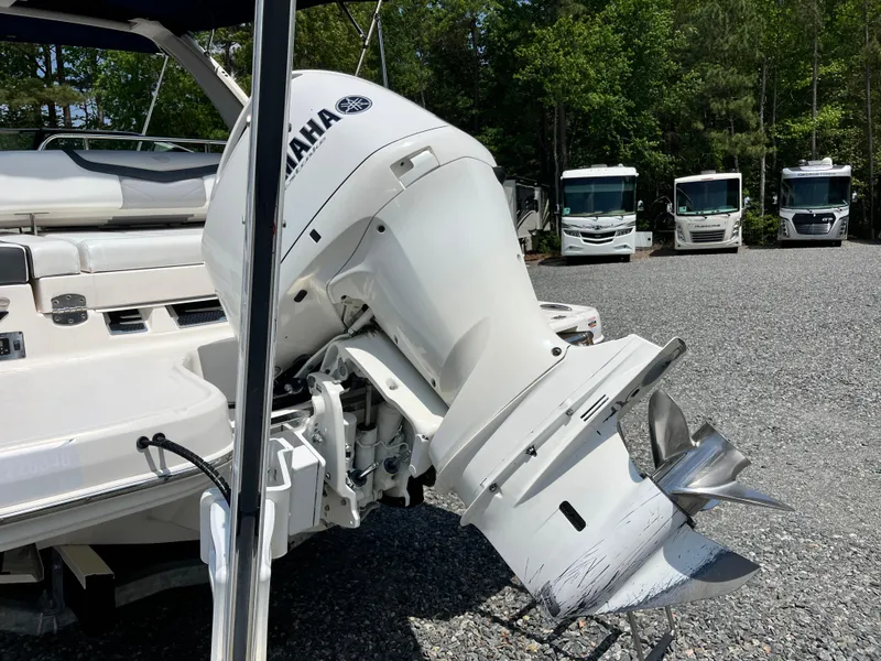 Slide: The Image of 2020 Chaparral 257 SSX boat with Yamaha outboard motor in a gravel lot. - 19