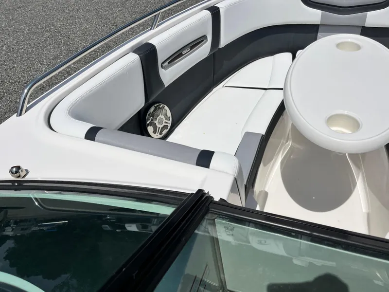 Slide: The Image of 2020 Chaparral 257 SSX boat interior with white seating and round table. - 7