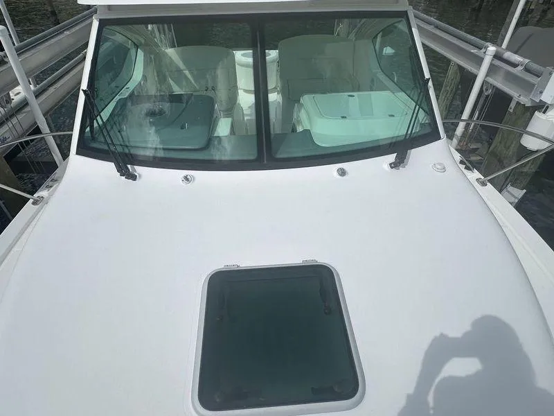 Slide: The Image of 2007 Tiara Yachts 3000 Open docked, showcasing sleek design and spacious cockpit. - 22