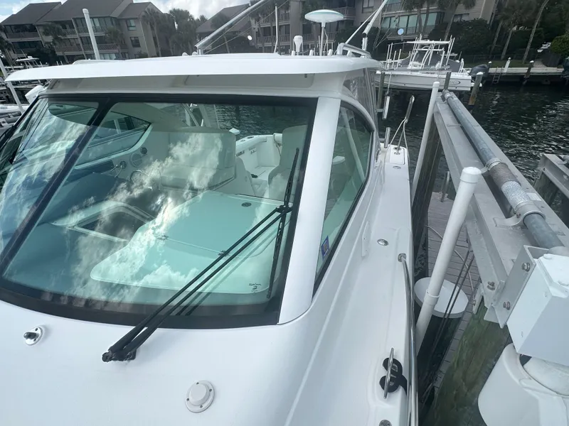 Slide: The Image of 2007 Tiara Yachts 3000 Open boat deck with marina view and clear sky. - 23