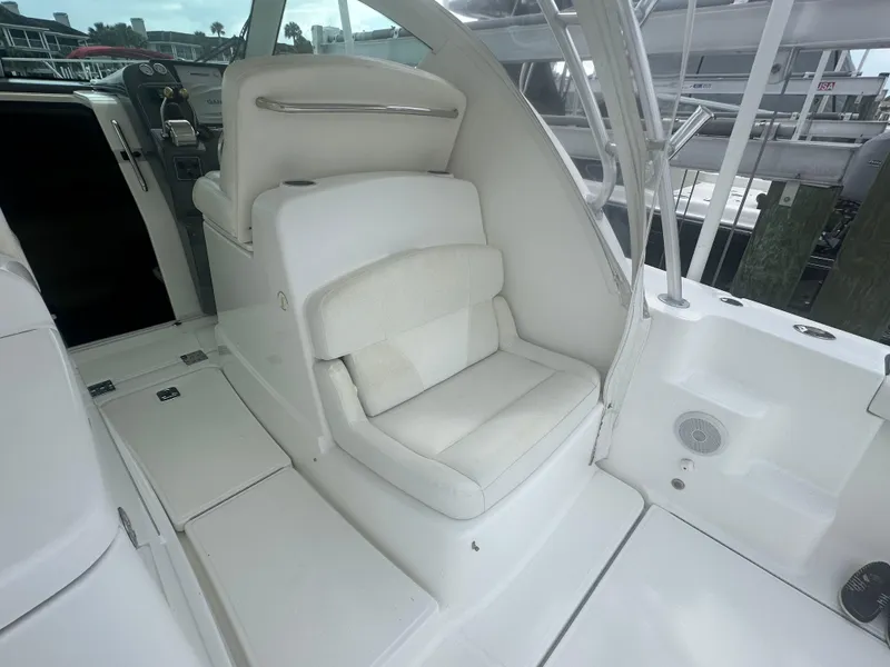 Slide: The Image of 2007 Tiara Yachts 3000 Open interior with kitchenette, wooden stairs, and compact design. - 26